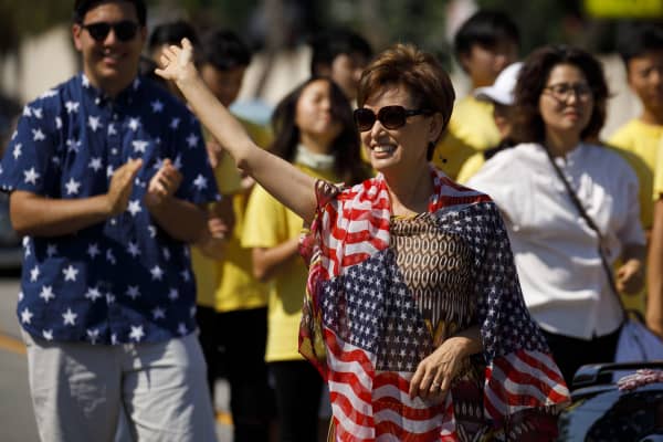 Young Kim, Republican U.S. Representative candidate from California, waves during a Fourth of July parade in Hacienda Heights, California, on Wednesday, July 4, 2018. 