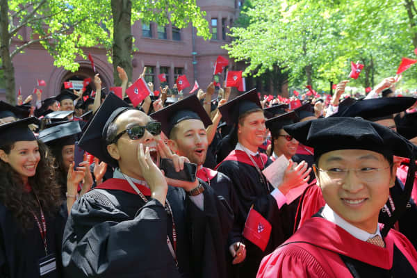 Brian Yeh, center, yells as the business degrees are conferred during the 367th Harvard University Commencement in Cambridge, MA on May 24, 2018.
