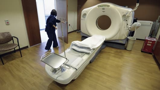 A CT scan technician prepares for a patient at the Silver Cross Emergency Care Center in Homer Glen, Ill. The Trump administration is quietly trying to weaken radiation rules, relying on scientific outliers who argue that a little radiation damage is actually good for you _ like a little bit of sunlight. 