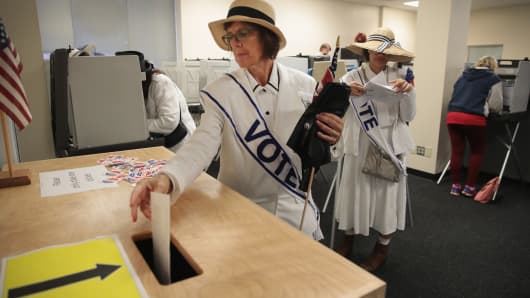 A woman dressed as a suffragette casts her ballot for the midterm elections at the Polk County Election Office on October 8, 2018 in Des Moines, Iowa.Today was the first day of early voting in the state. 
