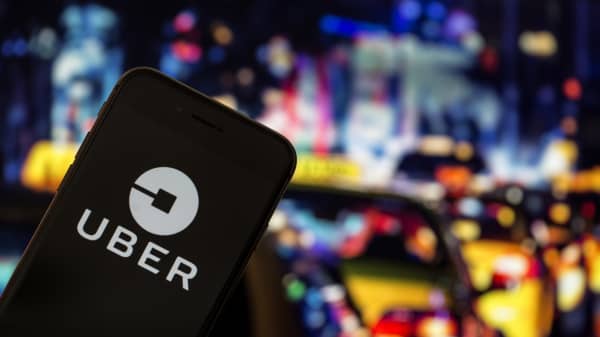 Uber application logo is seen on a screen in front of taxi board in Ankara, Turkey on August 31, 2018.