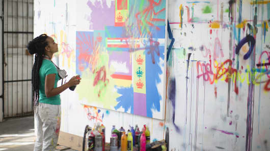 Young female artist working in her studio