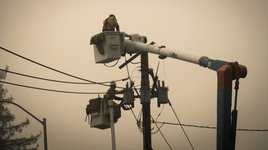 Pacific Gas & Electric Co (PG & E) workers repair a transformer in Paradise, California on Thursday, November 15, 2018.