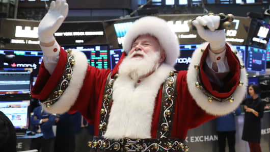 Santa Claus pays a visit on the floor at the New York Stock Exchange, November 21, 2018.