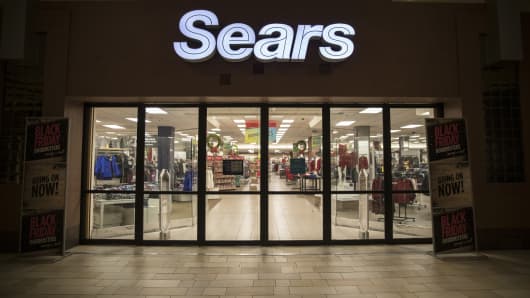 Entrance doors stand locked before opening hours at a Sears Holdings Corp. store on Black Friday at the Newport Centre Mall in Jersey City, New Jersey.