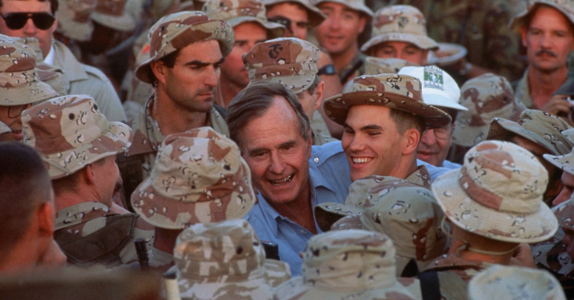 President George Bush shakes hands with US Army troops in Saudi Arabia during the Gulf War on Thanksgiving Day, 1990. (