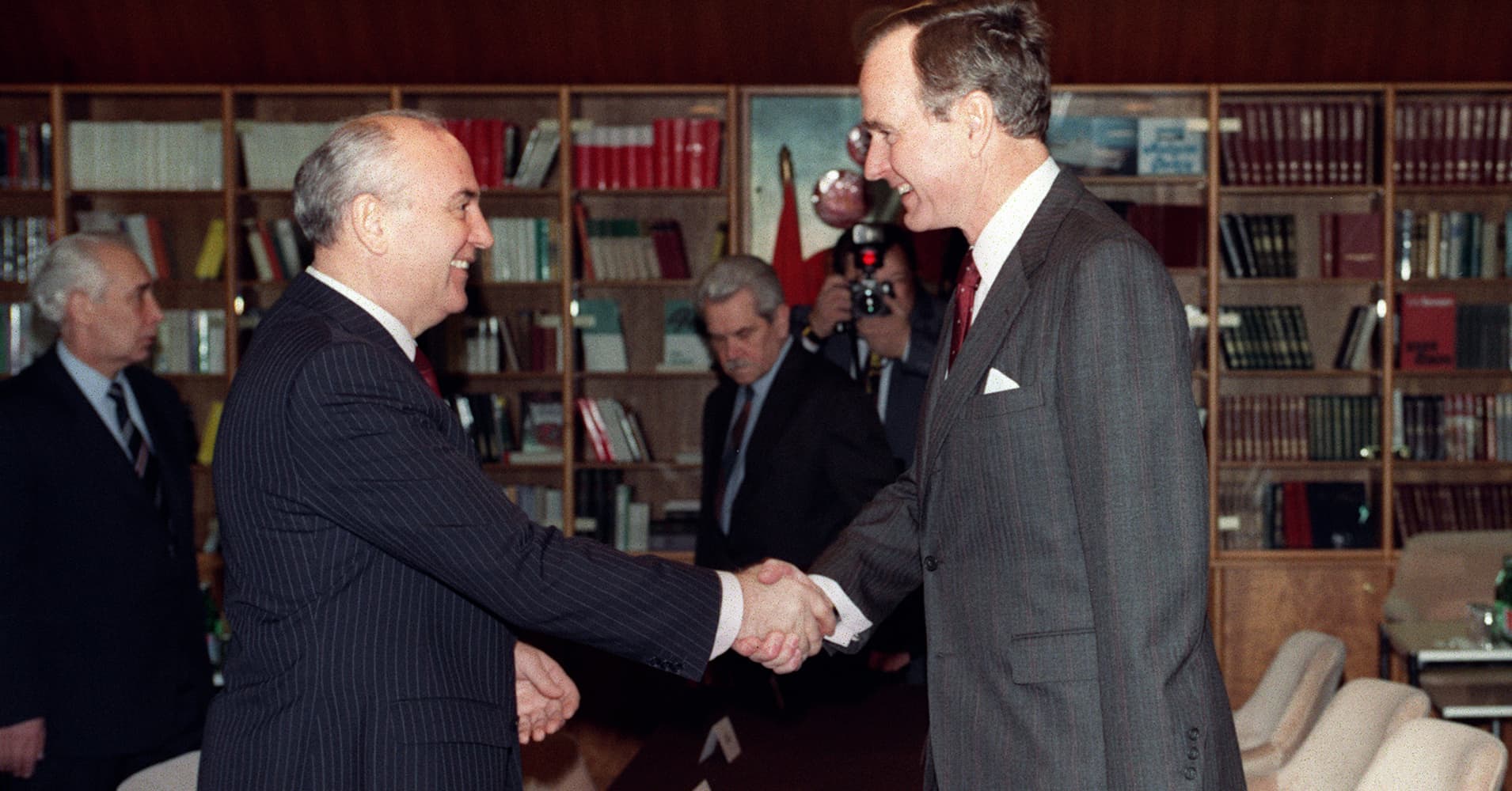 Soviet leader Mikhail Gorbachev (L) and US President George Bush (R) shake hands on December 02, 1989 on board the soviet cruise 'Maxim Gorki', shipdocked at Marsaxlokk harbour, before the start of their first summit meeting, just a few weeks after the fall of the Berlin Wall. This summit is viewed as the official end of the Cold War. 