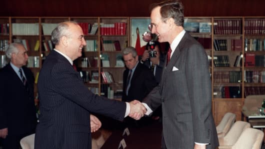 Soviet leader Mikhail Gorbachev (L) and US President George H.W. Bush (R) shake hands on December 2, 1989, aboard the Soviet cruise ship Maxim Gorki before the start of their first summit meeting, just a few weeks after the fall of the Berlin Wall. The summit is viewed as the official end of the Cold War. 