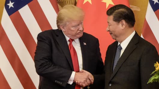 President Donald Trump (L) shakes hand with China's President Xi Jinping at the end of a press conference at the Great Hall of the People in Beijing on November 9, 2017. 