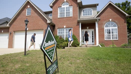 Prospective home buyers arrive with a realtor to a house for sale in Dunlap, Illinois, U.S., on Sunday, Aug. 19, 2018.