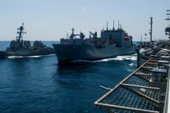 Photograph of guided-missile destroyer USS McCampbell, dry cargo/ammunition ship USNS Cesar Chavez and aircraft carrier USS Ronald Reagan during a replenishment-at-sea exercise in waters off the coast of Japan, May 15, 2018