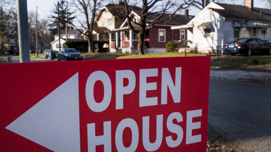 An 'Open House' sign is displayed in the front yard of a home for sale in Columbus, Ohio.