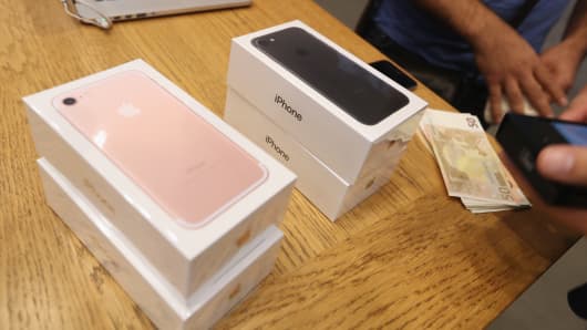 A customer buys four Apple iPhone 7 phones on the first day of sales of the new phone at the Berlin Apple store on September 16, 2016 in Berlin, Germany.