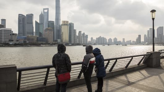 Los peatones se ubican a lo largo del Bund como rascacielos del distrito financiero de Pudong Lujiazui, que se alza a lo largo del río Huangpu en Shanghai, China, el viernes 28 de diciembre de 2018.
