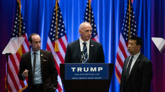 Stephen Miller, senior policy advisor for the Trump campaign, and Keith Schiller, chief of security for the Trump campaign, check the podium before Republican Presidential candidate Donald Trump speaks during an event at Trump SoHo Hotel, June 22, 2016 in New York City.