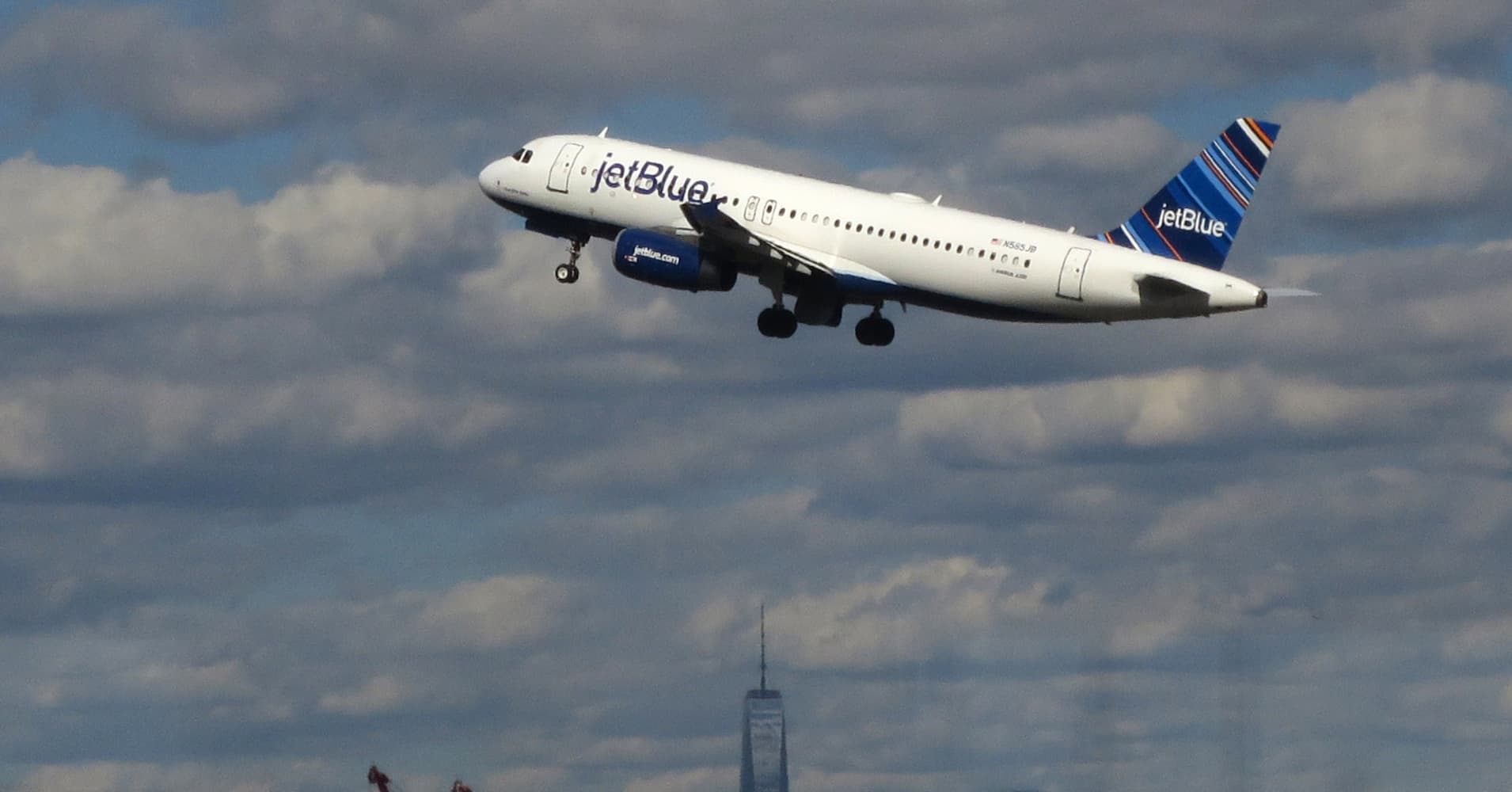 A jetBlue airplane flies over New York's Lower Manhattan as it takes off from Newark Liberty International Airport in Newark, New Jersey.