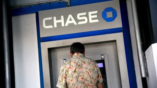   A customer uses a JPMorgan Chase & Co. automatic vending machine (ATM) outside a bank office in Miami, Florida, USA, Thursday, January 5, 2017. J 
