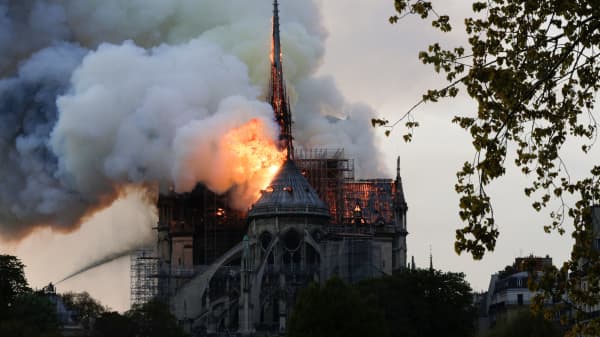 Flames and smoke are seen billowing from the roof at Notre-Dame Cathedral in Paris on April 15, 2019.