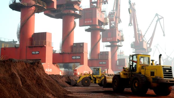 Workers transport soil containing rare earth elements for export at a port in Lianyungang, Jiangsu province, China October 31, 2010.