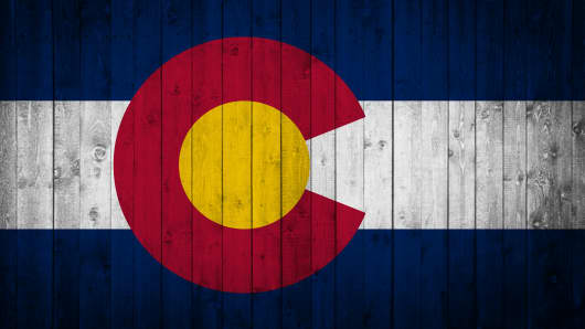 Colorado State flag is painted on a wooden surface
