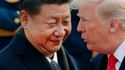 Chinese President Xi Jinping chats with President Donald Trump during a welcome ceremony in Beijing on Nov. 9, 2017.