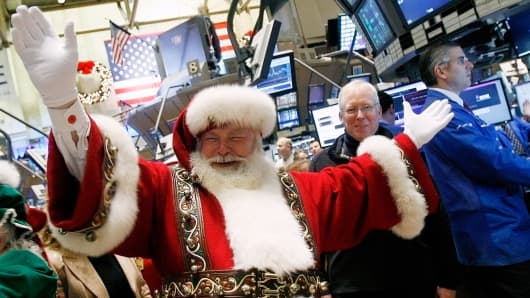 A man dressed as Santa Claus walks the floor of the New York Stock Exchange.